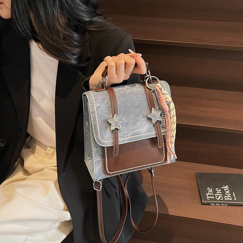 Denim backpack held by hand